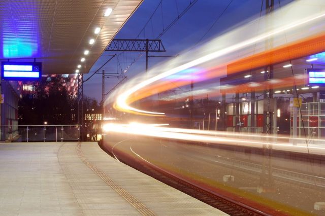 Zug fährt durch Bahnhof