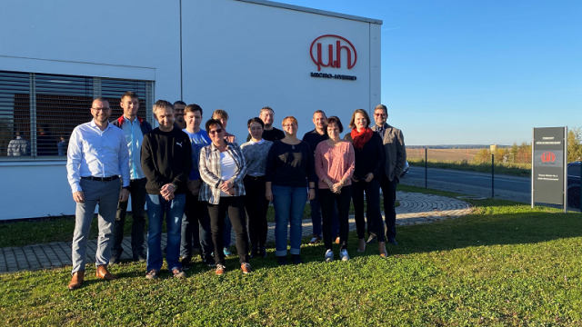 Team in front of building